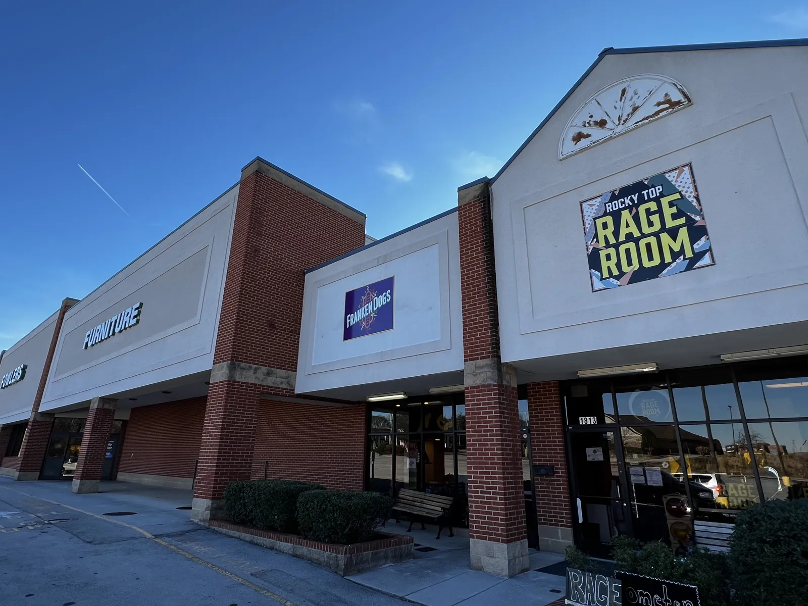 The Franken Dogs storefront on W Broadway Ave, next to Rocky Top Rage Room